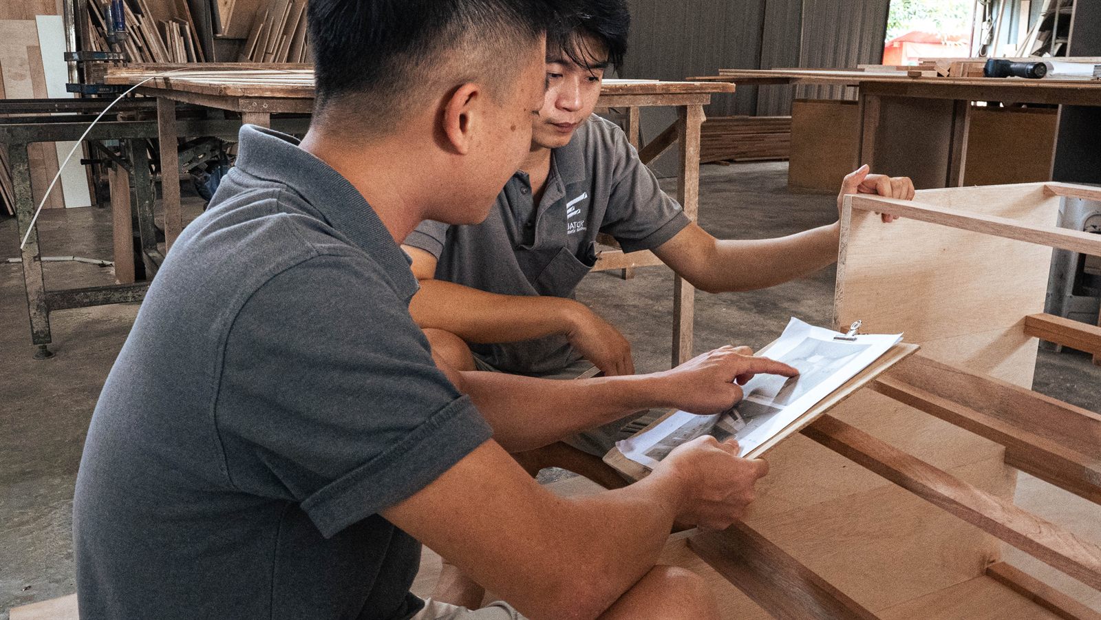 Equator craftsmen reviewing a drawing in the factory